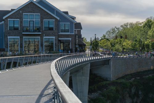 Explore the scenic pedestrian bridge in Dublin, Ohio, showcasing modern architecture and lush surroundings.