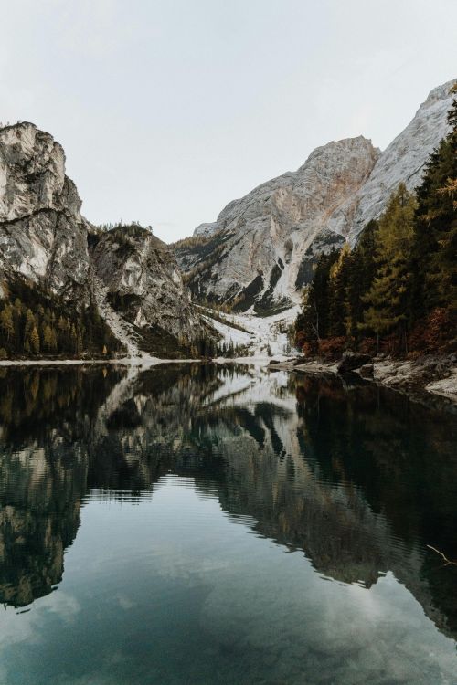 Calm waters reflect stunning mountains at Lake Braies in Trentino-South Tyrol, Italy.